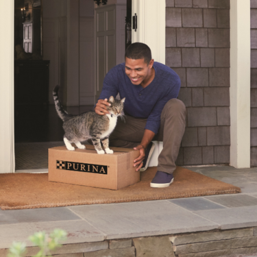 Owner and Cat receiving Purina delivery.  